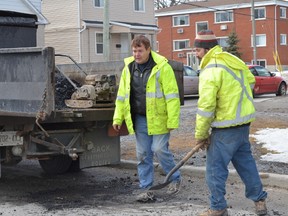 Crews were out patching potholes around the city Friday. But with  snowfall expected overnight, it may be more of a temporary fix. 
Michelle Ferguson/For The Whig-Standard