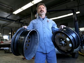 Floriano Rodrigues of Cosme Auto Services Ltd. shows tire rims damaged by potholes in Kingston on Friday. 
IAN MACALPINE/KINGSTON WHIG-STANDARD/QMI AGENCY