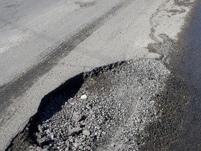 A large pothole on Rideau Street is just one of hundreds of potholes in Kingston on Friday. 
IAN MACALPINE/KINGSTON WHIG-STANDARD/QMI AGENCY