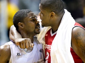 DeAndre Thomas of the Windsor Express wraps his arm around London Lightning?s Tony Bennett as Bennett has a heated exchange with Thomas?s teammate George Goode at the end of their NBL playoff game at Budweiser Gardens on Thursday. (DEREK RUTTAN, The London Free Press )