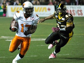 BC Lions running back Jock Sanders runs the ball past Hamilton Tiger-Cats linebacker Brandon Denson (R) during the first half of their CFL football game in Hamilton October 22, 2011.  REUTERS/Mike Cassese