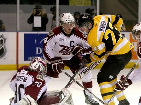Kingston Frontenacs Henri Ikonen pokes the puck past Peterborough Petes goalie Andrew D'Agostini as defenceman Connor Boland looks on during Ontario Hockey League Game 1 of the Eastern Conference quarter-final action at the Rogers K-Rock Centre on Friday.
IAN MACALPINE/KINGSTON WHIG-STANDARD/QMI AGENCY
