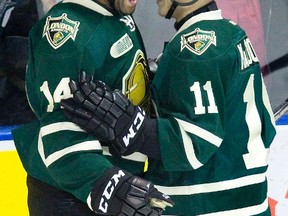 London Knights Gemel Smith (left) and Owen Macdonald (cct) celebrate after Macdonald's scored in the second period of their hockey game during OHL action in London, Ont. on Friday, March 21, 2014. No penalty was assessed on the play.DEREK RUTTAN/ The London Free Press /QMI AGENCY