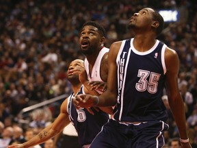 Raptors' Amir Johnson And Kevin Durant  of the Thunder look for the ball to drop at the ACC on Friday night. (Jack Boland/Toronto Sun)