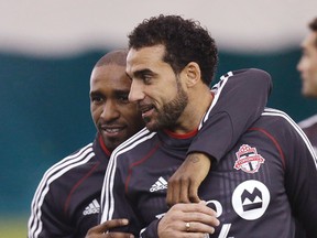 Toronto FC star Jermain Defoe hugs Dwayne De Rosario at training on March 21. (Craig Robertson, Toronto Sun)