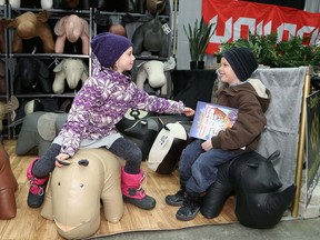 JOHN LAPPA/THE SUDBURY STAR/QMI AGENCY 
Shayla Pagnutti, 8, left, and her brother, Dylan, 6, have a seat on leather ottomans made to look like animals at the Sudbury and District Home Builders' Association Sudbury Home Show at the Sudbury Community Arena on Friday. The show continues Saturday from 10 a.m. to 5 p.m. and Sunday from 10 a.m. to 4 p.m.