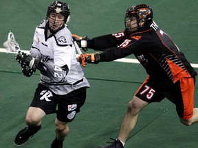 The Edmonton Rush's Mark Matthews (42) battles the Buffalo Bandits' Jay Thorimbert (75) during first half National Lacrosse League action at Rexall Place, in Edmonton Alta., on Friday March 21, 2014. David Bloom/Edmonton Sun/QMI Agency