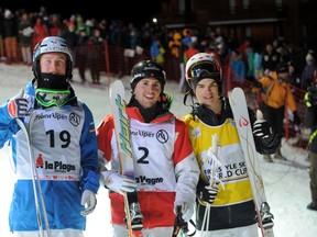 From left to right, third-place Benjamin Cavet of France, winner Alex Bilodeau of Canada, and second-place Mikael Kingsbury of Canada pose at the end of the Men's Moguls final of the Freestyle Skiing World Cup in La Plagne, France, on Friday, March 21, 2014. (Jean-Pierre Clatot/AFP)