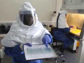 A doctor displays collected samples of the Ebola virus at the Centre for Disease Control in Entebbe, about 37km (23 miles) southwest of Uganda's capital Kampala, August 2, 2012. REUTERS/Edward Echwalu