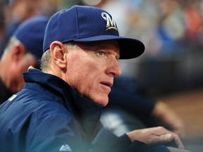 Manager Ron Roenicke #10 of the Milwaukee Brewers disputes a call with an umpire during the game against the Atlanta Braves at Turner Field on September 24, 2013 in Atlanta, Georgia. (Scott Cunningham/Getty Images/AFP)