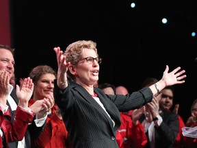 Ontario Premier Kathleen Wynne react to cheers as she prepares to address the Ontario Liberals Annual General Meetin in Toronto an March 22, 2014. (Stan Behal/Toronto Sun)