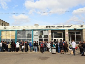 People line up outside the Boyle Street Community Services, 10116 - 105 Ave., for a Thanksgiving dinner, Sunday October 7, 2012. 1,400 people were expected to attend.  DAVID BLOOM EDMONTON SUN  QMI AGENCY