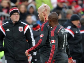 Toronto FC defender Michael Bradley heads off the field to get medical attention against D.C. United at BMO Field on Saturday. (Tom Szczerbowski-USA TODAY Sports)