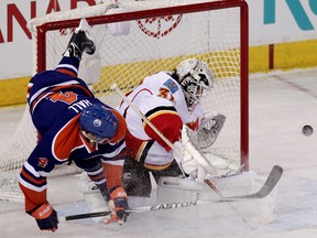 The Edmonton Oilers Taylor Hall (4) collides with the Calgary Flames goalie Karri Ramo (31) during first period NHL action at Rexall Place, in Edmonton Alta., on Saturday March 22, 2014. David Bloom/Edmonton Sun/QMI Agency