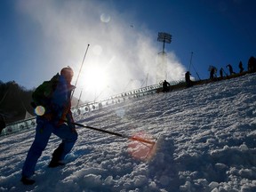 Workers prepare the RusSki Gorki ski jump venue at the Rosa Khutor alpine resort near Sochi, February 4, 2014. REUTERS/Michael Dalder
