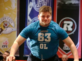 Matthias Goossen offensive lineman from Simon Fraser  at the standing long jump  during CFL Combine  in Toronto, Ont. on Saturday March 22, 2014. Craig Robertson/Toronto Sun/QMI Agency