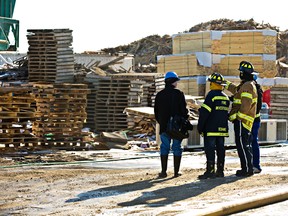 Fire investigators are at the scene of a fire at Lone Star Lumber at 165 Street and 128 Avenue in Edmonton, Alta., on Friday, March 21, 2014. Codie McLachlan/Edmonton Sun/QMI Agency