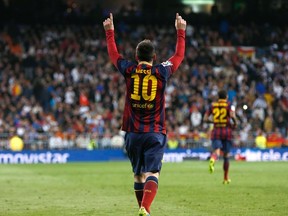 Barcelona's Lionel Messi celebrates after scoring a penalty goal against Real Madrid during La Liga's second 'classic' soccer match of the season at Santiago Bernabeu stadium in Madrid March 23, 2014.  (REUTERS)