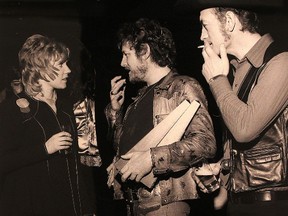 Canadiana at its finest in this Bruce Cole photograph from the 1973 Junos in Toronto, Ont. Gordon Lightfoot (centre) holds a pair of awards while in discussion with Anne Murray (left) as male vocalist of the year Stompin' Tom Connors looks on. Note the 'stubby' beer bottle on a chair. It's among the photos on display as part of a Juno photography exhibit at Gurevich Fine Art on Albert Street in Winnipeg, Man. Photographed on Sat., March 22, 2014. (Kevin King/Winnipeg Sun)