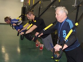 Harold Carmichael/The Sudbury Star
Sudbury YMCA members Guy Henry, left, and Gerry St. Louise, right, along with instructor Kevin Chenard work out in the TRX Suspension Training area at the Sudbury YMCA in this file photo. The YMCA in Sudbury and North Bay is in contract talks with OPSEU.