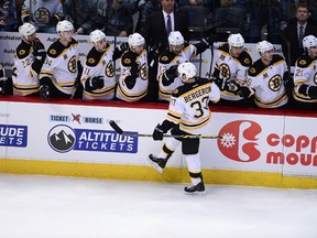 Boston Bruins centre Patrice Bergeron (37) is congratulated for his goal against the Colorado Avalanche in the first period at the Pepsi Center on March 21, 2014. (RON CHENOY/USA TODAY Sports)