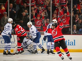 Stephen Gionta #11 of the New Jersey Devils celebrates a goal scored by Jon Merrill #34 of the New Jersey Devils against the Toronto Maple Leafs during the second period at the Prudential Center on March 23, 2014 in Newark, New Jersey. (Adam Hunger/Getty Images/AFP)