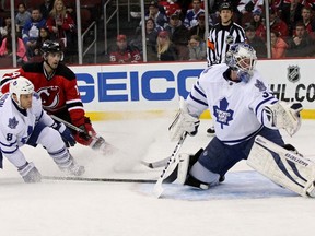 Maple Leafs defenceman Tim Gleason and New Jersey Devils centre Adam Henrique watch as a shot by Devils winger Damien Brunner (not pictured) beats goalie James Reimer in the first period last night at Prudential Center. (Noah K. Murray/USA Today Sports)