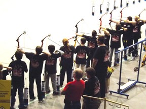Students from St. Anthony School line up to shoot during the NASP Provincials held during the Edmonton Boat and Sportsman Show on Mar. 15.