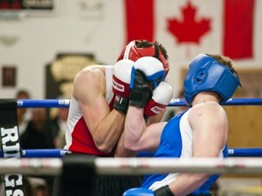 Ben Alvarez from Edmonton's Panther Boxing Club deflects a killer uppercut from Blue Ridge Boxing Club's Randy Thompson in the main event fight during Saturday, March 22nd's fight night in Whitecourt. Bryan Passifiume | QMI Agency