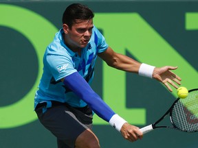 Milos Raonic hits a backhand against Guillermo Garcia-Lopez (not pictured) on day eight of the Sony Open at Crandon Tennis Center on Mar 24, 2014 in Miami, FL, USA. (Geoff Burke/USA TODAY Sports)