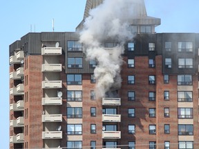 Smoke can be seen billowing out from a fire in a highrise on Baycrest Drive in east Ottawa at around 2:10 p.m. Monday, March 24, 2012 
Submitted photo from Craig McDowall