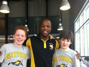 Former Kingston wrestler Cleopas Ncube poses with a couple of young wrestlers he coaches in Montreal, where he teaches at Selywn House, a private boys school. Ncube, 30, won the 74-kilogram division title at the Canadian wrestling championships in Edmonton on the weekend. (Supplied photo)