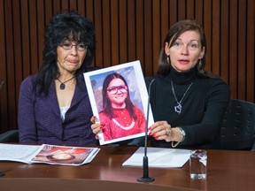 Toni Grann (right), along with fellow former Crown ward Holly Papassay, holds a photo of herself when she was a young girl during a press conference at the Queen's Park media gallery in Toronto Monday, March 24, 2014. (Ernest Doroszuk/Toronto Sun)