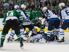 Mar 24, 2014; Dallas, TX, USA; Winnipeg Jets center Olli Jokinen (12) and defenseman Jacob Trouba (8) and 25#2\ and goalie Al Montoya (35) defend against Dallas Stars left wing Jamie Benn (14) and right wing Alex Chiasson (12) and center Tyler Seguin (91) during a power play during the second period at the American Airlines Center. Seguin scores a goal. Mandatory Credit: Jerome Miron-USA TODAY Sports