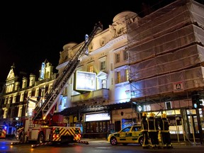 Emergency services look at the roof of the Apollo Theatre on Shaftesbury Avenue after part of the ceiling collapsed in central London December 19, 2013. (REUTERS/Neil Hall)