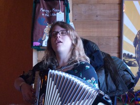 Anja McCloskey plays the accordion and sings in front of spectators at Harvest Coffeehouse. Greg Cowan photos/QMI Agency.