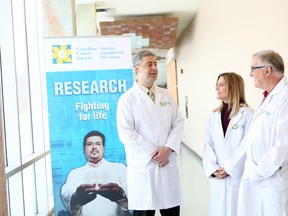 Dr. John Bell, far right, of the Ottawa Hospital Research Institute, one of three local researchers to get funding Tuesday, is developing viruses that will grow in and kill cancer cells in patients with the disease but won’t affect their normal tissues. His seen here with Dr. Andrew Makrigiannis, left, and Dr. Christine Maheu. Submitted photo