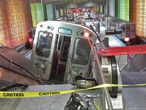A handout photo shows a derailed commuter train resting on an escalator at O'Hare international airport in Chicago March 24, 2014. REUTERS/NBC Chicago handout via Reuters