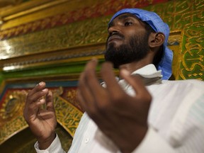 An Indian Muslim prays during Ramadan at the shrine of 13th century Sufi Muslim saint Hazrat Nizamuddin Aulia in New Delhi on August 12, 2012. Islam's holy month of Ramadan is calculated on the sighting of the new moon and Muslims all over the world are supposed to fast from dawn to dusk during the month.  AFP PHOTO/ Andrew Caballero-Reynolds