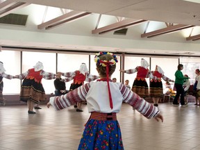 A young performer imitates a group of older dancers before the final show of the weekend at the Vermilion Ukrainian Dance Festival at Lakeland College.