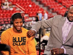 TNT analyst Shaquille O'Neal shares a laugh with Paul George of the Indiana Pacers following the Pacers victory against the Miami Heat in Game 2 of the Eastern Conference Finals during the 2013 playoffs on May 24, 2013. (Issac Baldizon/NBAE via Getty Images/AFP)