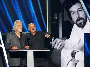 Tommy Chong (L) and Cheech Marin of the comedic duo Cheech and Chong induct producer Lou Adler at the 2013 Rock and Roll Hall of Fame induction ceremony in Los Angeles April 18, 2013. (REUTERS/Mario Anzuoni)