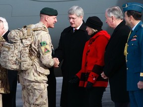 Maj.-Gen Dean Milner shakes hands with Prime Minister Stephen Harper after arriving from Afghanistan, in Ottawa on March 18. 
REUTERS/QMI Agency