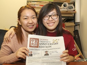 Executive director Laureen Hu, left, and editor-in-chief Jane Shui hold up the 20th anniversary edition of The Empress, a bilingual, student-run publication on the Queen's University campus.
Michael Lea The Whig-Standard