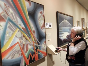 Heather Mousseau of the Winnipeg Art Gallery looks at "Sounds Assembling" by artist Bertram Brooker as part of the Canadian Juno Art Tour in Winnipeg, Man. Tuesday March 25, 2014. (Brian Donogh/Winnipeg Sun/QMI Agency)