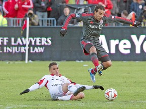 D.C. United forward Luis Silva takes up some grass while challenging TFC’s Dwayne De Rosario on Saturday at BMO Field. (USA TODAY SPORTS)