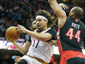 Cavaliers centre Anderson Varejao (17) looks to pass against Toronto Raptors forward Chuck Hayes (44) during the second quarter in Cleveland on Tuesday night. (Ron Schwane-USA TODAY Sports)