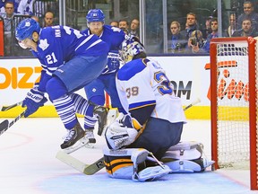 Leafs forward James van Riemsdyk jumps out of the way of a shot in front of Blues goalie Ryan Miller on Tuesday night at the ACC. (DAVE ABEL/Toronto Sun)