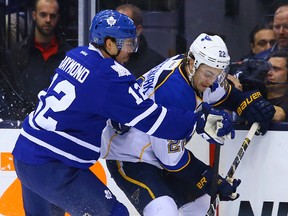 Maple Leafs’ Mason Raymond rubs Blues’ Kevin Shattenkirk along the boards on Tuesday night in Toronto. (DAVE ABEL/TORONTO SUN