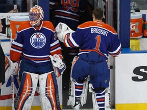 Oilers goalie Ben Scrivens gets a tap on the pads from backup Laurent Brossoit after Tuesday's game against the San Jose Sharks at Rexall Place. (Ian Kucerak, Edmonton Sun)